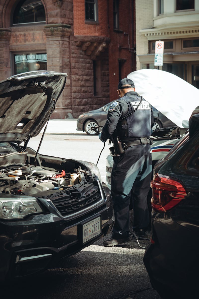 A police officer assists a car with a breakdown on the streets of Washington DC.